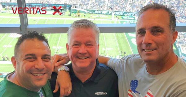 Men smiling in Skybox at football game